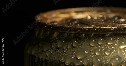 Beautiful frame for advertising alcohol products, macro shot of golden aluminum can, metal covered with large drops of water, fresh drink, sealed packaging, chilled lemonade, alcohol in metal package