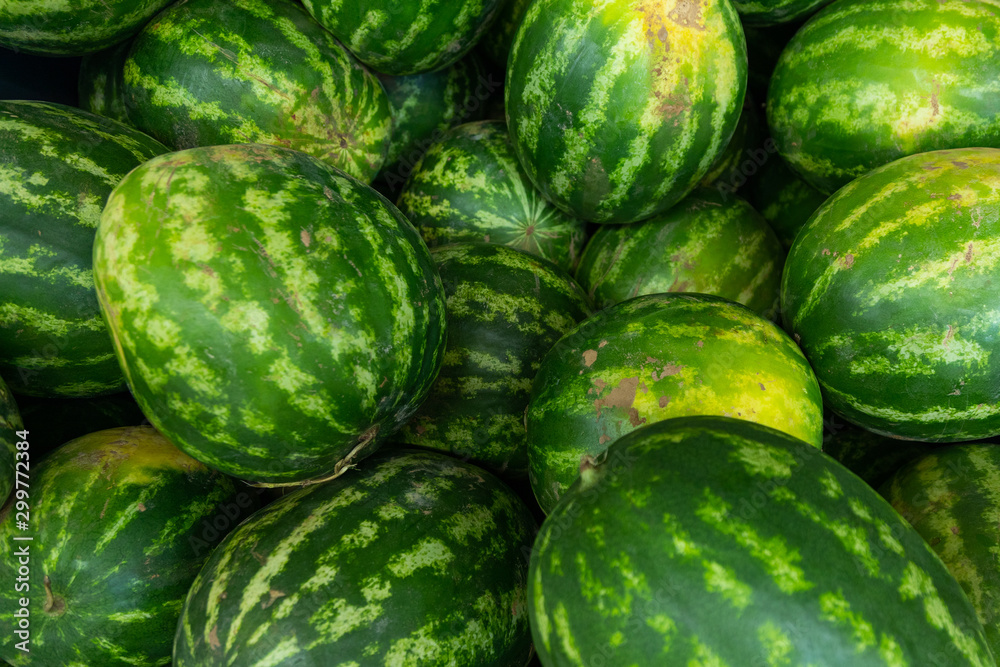 Striped fresh ripe green watermelon background ar farmer's market or grocery store. Harvest illustration photo. Striped fresh ripe green watermelon background ar farmer's market or grocery store. Harvest illustration photo.