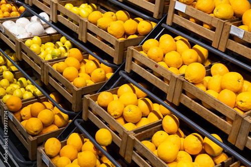 Many wooden lug boxes with yellow lemons on counter photo