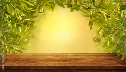 Mockup of empty table with olives branches with fresh olives on yellow background.