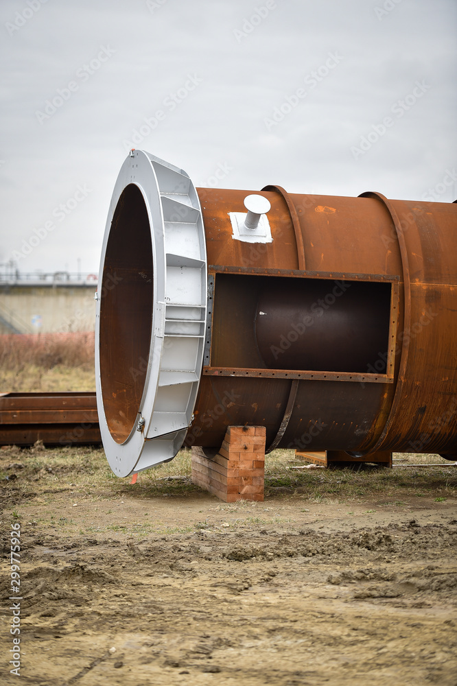 Detail with a huge industrial pipe on a construction site. Detail with a huge industrial pipe on a construction site.