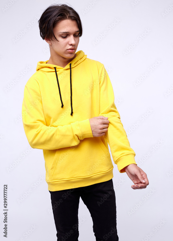 photo of man wearing yellow hoodie isolated on white background. photo of man wearing yellow hoodie isolated on white background.