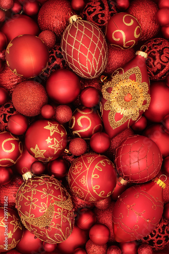 Luxury red and gold bauble christmas tree decorations forming an abstract background. Traditional view for the festive season.