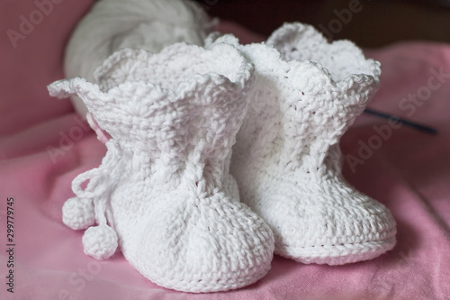 White handmade booties for the baby.