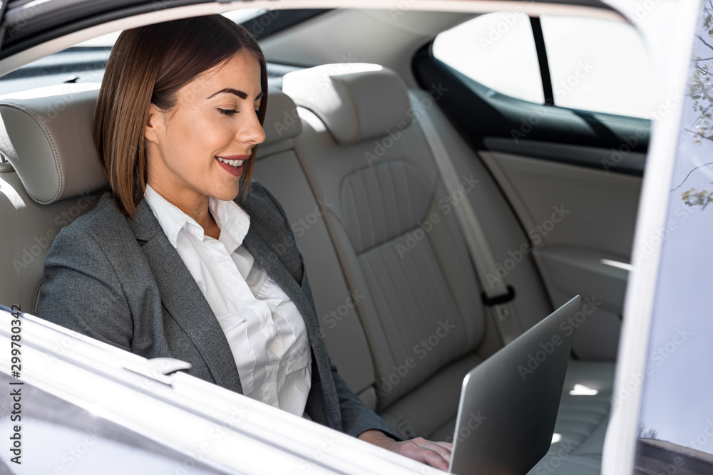 Beautiful young business woman is driving in the car to work Beautiful young business woman is driving in the car to work