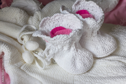 White handmade booties for the baby. © Tatiana