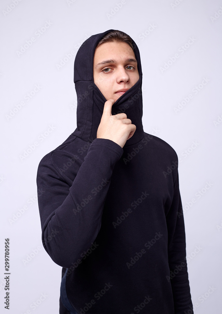 photo of man wearing black hoodie isolated on white background. photo of man wearing black hoodie isolated on white background.