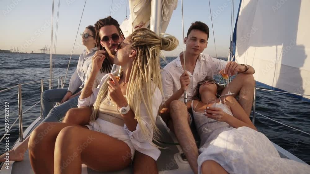 Young people relaxing on a yacht. Party on a yacht. Corporate party on a yacht. Young people having fun on a yacht. Walk on a yacht along the river. Cruise on a boat. Close up Young people relaxing on a yacht. Party on a yacht. Corporate party on a yacht. Young people having fun on a yacht. Walk on a yacht along the river. Cruise on a boat. Close up