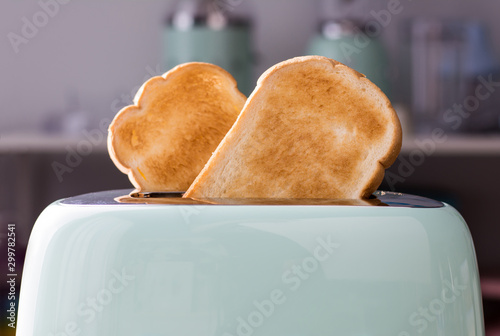 Close up of Bread slices in a green toaster