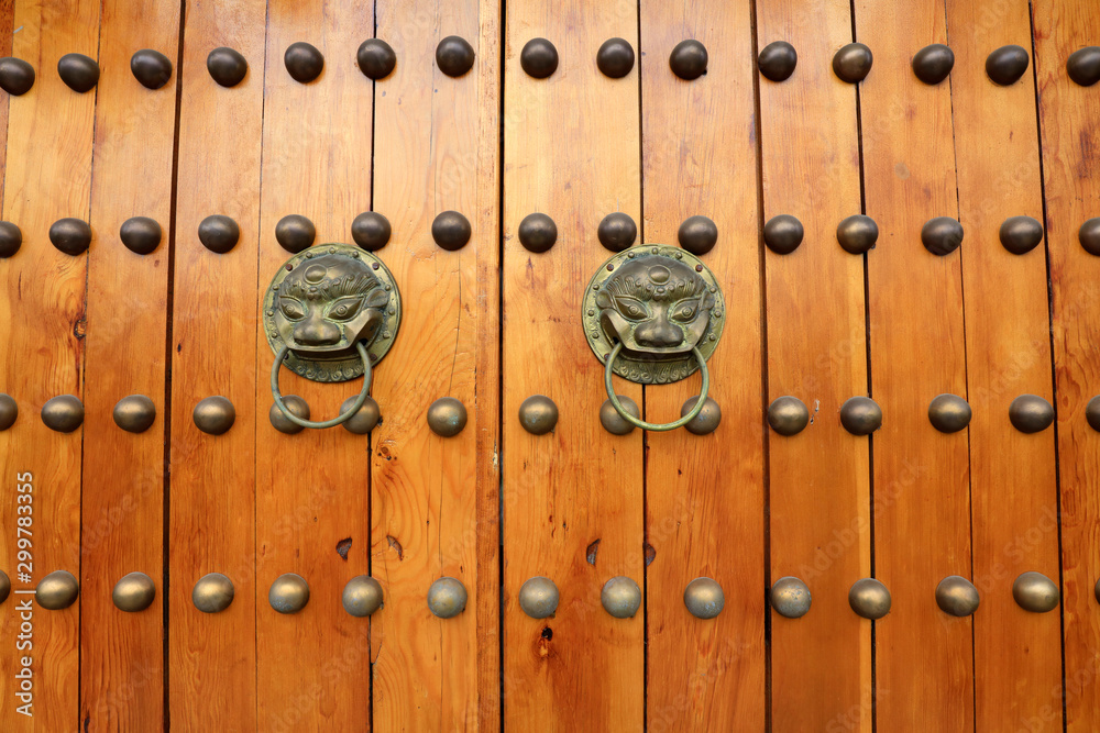 Fototapeta premium wooden door knocker on metal