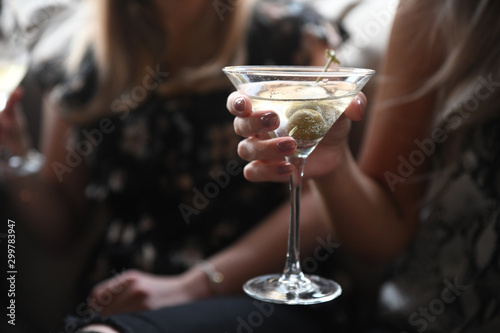 Close up of woman holding cocktail drink photo