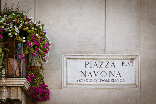 Piazza Navona  sign with colorful hanging flowers