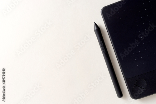 Black graphic tablet with pen for illustrators and designers. Graphic digital touch tablet with White background and stylus pen