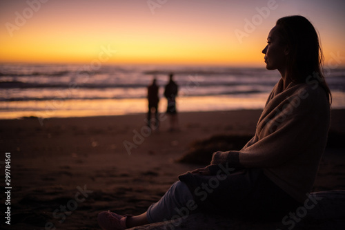 Woman enjoying sunset near ocean
