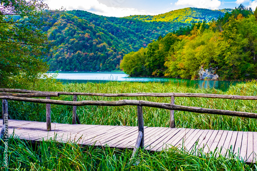 Wooden pathway and clear water in National Park Plitvice Lakes in autumn, Croatia