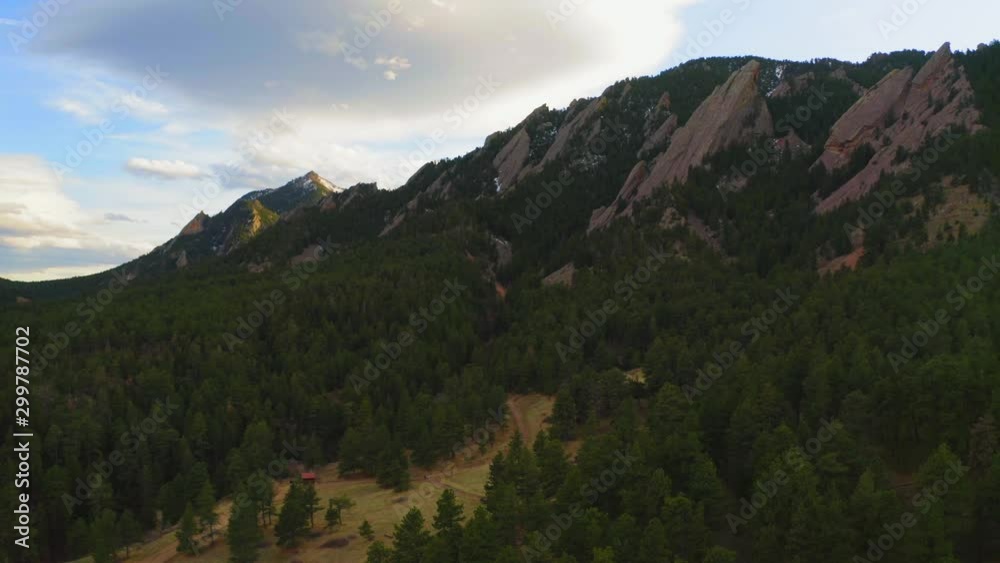 Aerial: Trees in forest by rocky mountains against sky during sunset - Boulder, Colorado Aerial: Trees in forest by rocky mountains against sky during sunset - Boulder, Colorado