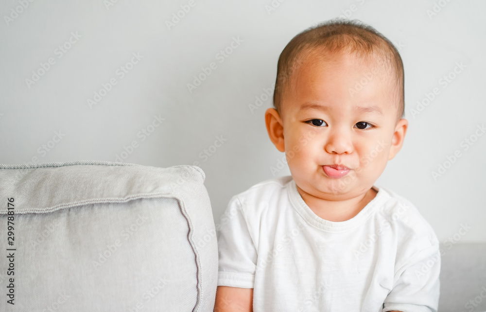 Cute adorable one year seven month old baby boy.Closeup of adorable asian boy child, little baby boy on sofa at home. Cute adorable one year seven month old baby boy.Closeup of adorable asian boy child, little baby boy on sofa at home.