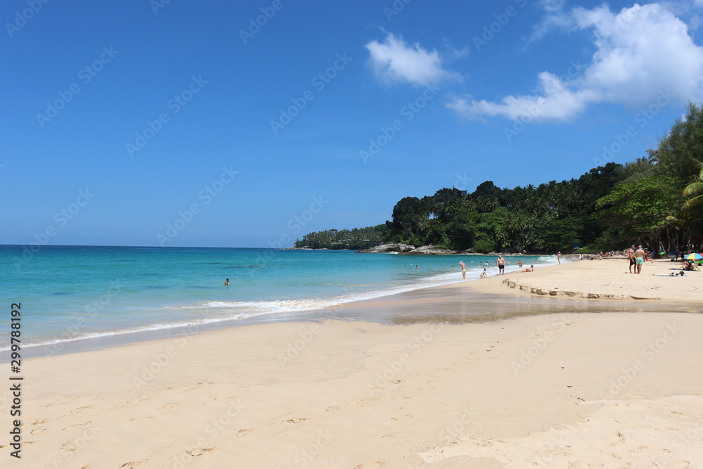 view of patong beach in phuket, sea waves roll on the sandy shore, foam and spray of water