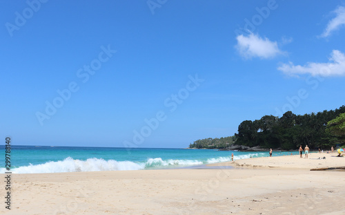 Fototapeta Naklejka Na Ścianę i Meble -  view of patong beach in phuket, sea waves roll on the sandy shore, foam and spray of water