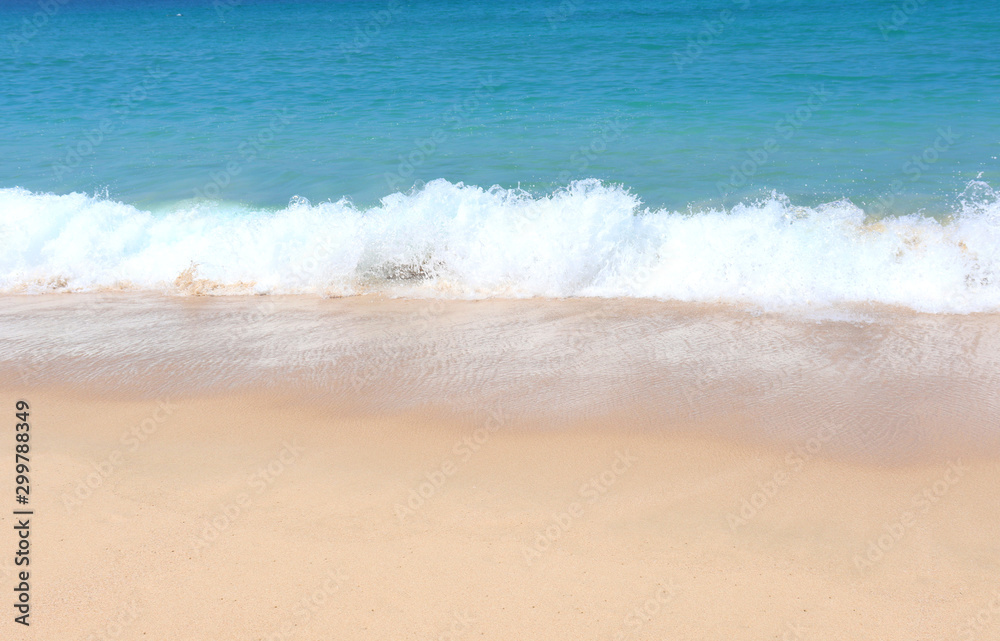 view of patong beach in phuket, sea waves roll on the sandy shore, foam and spray of water