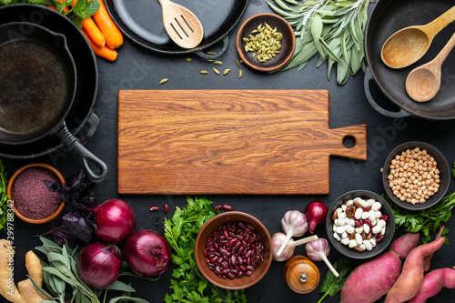 Dark culinary background with healthy food ingredients photo