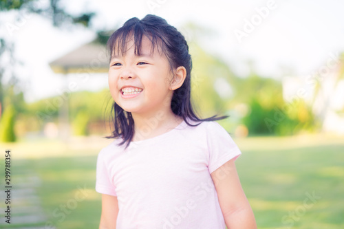 4 years old.Little Asian girl playing sand in the park.She very happy and big smile: Healthy happy funny smiling face young adorable lovely female kid with new home. © MIA Studio