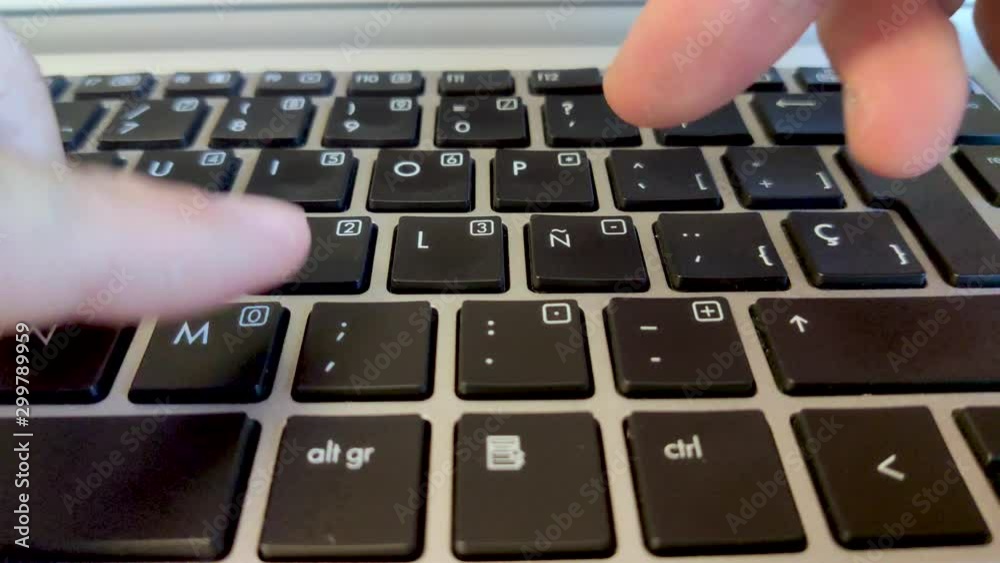 Finger presses the special character N with a with a squiggly line on top on the spanish keyboard. The sund ny is represented in spanish languages as a N with the little squiggly Finger presses the special character N with a with a squiggly line on top on the spanish keyboard. The sund ny is represented in spanish languages as a N with the little squiggly