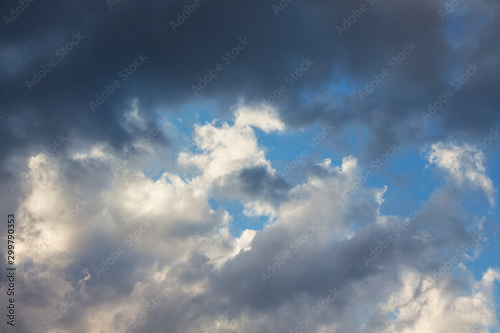 Dark storm clouds in blue sky, background for design_