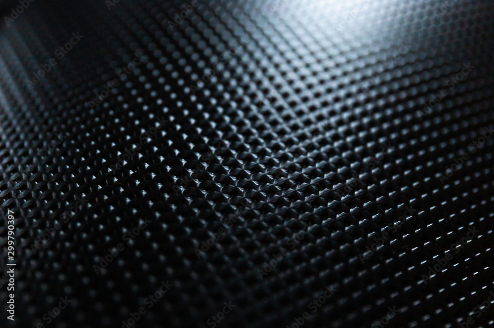 Close Up of Light Bouncing Off a Black Textured Notebook Cover - obrazy, fototapety, plakaty 