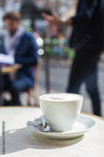 view sitting enjoying coffee on street of Paris outdoor cafe 