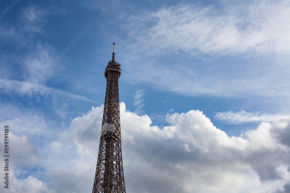 Top of the Eiffel Tower in Paris France October 2019 beautiful cloudy blue skies Top of the Eiffel Tower in Paris France October 2019 beautiful cloudy blue skies