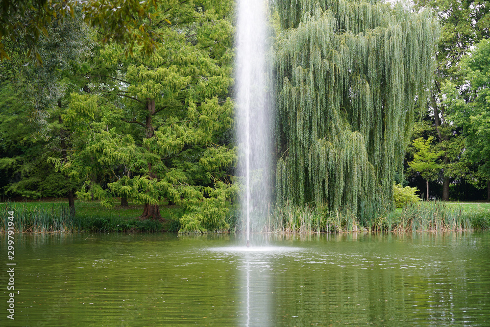 Fountains and garden pond in a public park invite you to relax