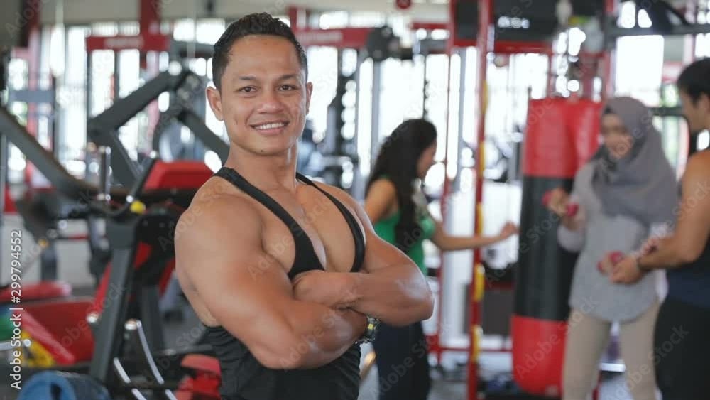 Handsome muscle man with crossed hands, feeling his strenght and confidence posing at camera Handsome muscle man with crossed hands, feeling his strenght and confidence posing at camera