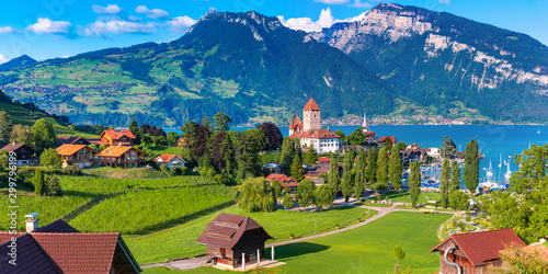 Aerial panoramic view of Spiez Church and Castle on the shore of Lake Thun in the Swiss canton of Bern at sunset, Spiez, Switzerland.