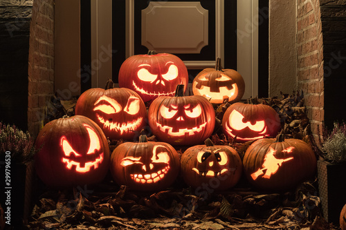 Night shot of illuminated pumpkins in front of a house