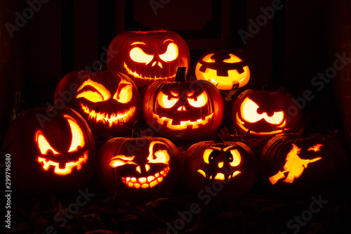Night shot of illuminated pumpkins in front of a house