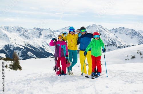 Happy family enjoying winter vacations in mountains . Ski, Sun,Snow and fun.