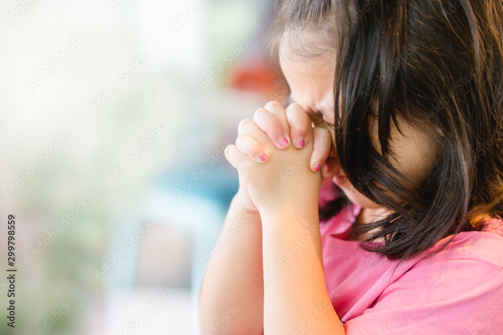 Little girl praying in the morning.Little asian girl hand praying,Hands folded in prayer concept for faith,spirituality and religion. Little girl praying in the morning.Little asian girl hand praying,Hands folded in prayer concept for faith,spirituality and religion.