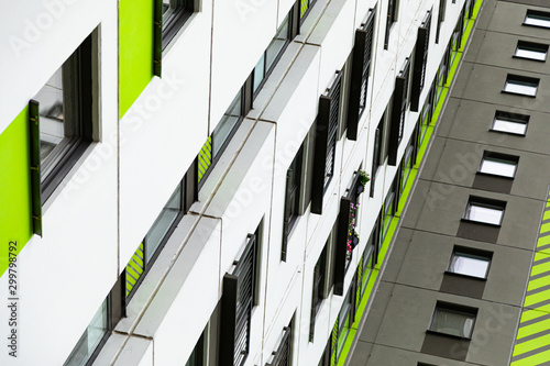 Bottom view of high new multiple dwelling of white, green and grey colors photo