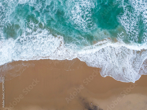Sand beach aerial, top view of a beautiful sandy beach aerial shot with the blue waves rolling into the shore © nvphoto