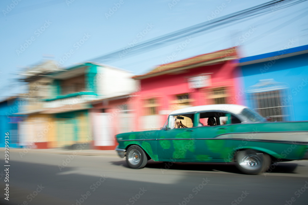 Old car blurring by on the streets of Trinidad, Cuba.