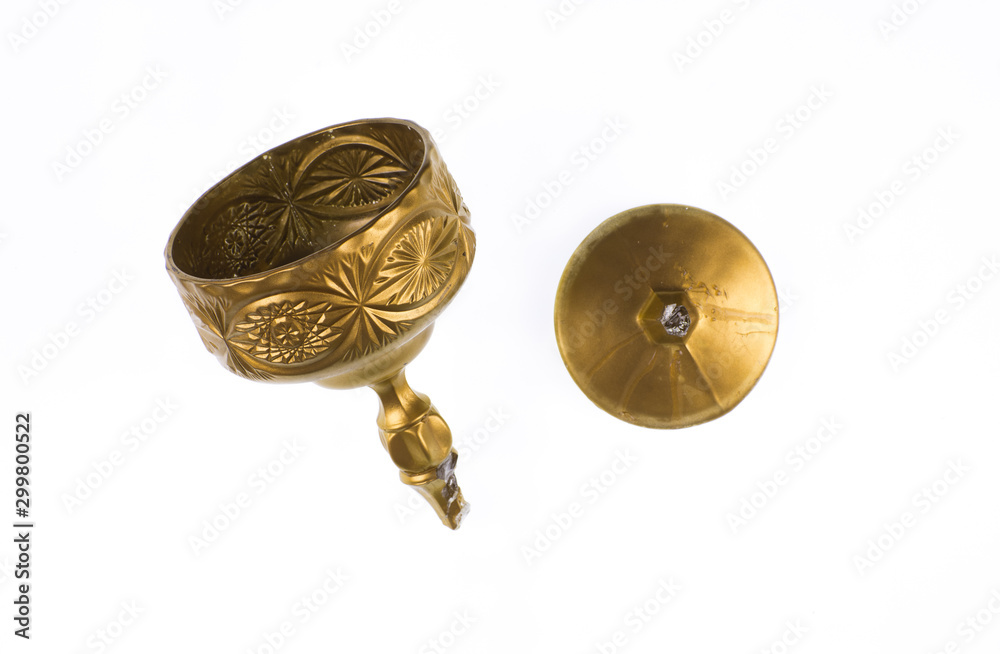 broken golden glass on a white background broken golden glass on a white background