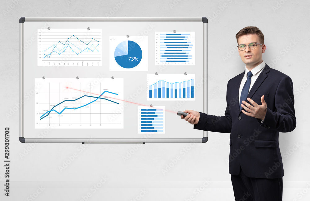 Handsome businessman presenting report on white board with laser pointer Handsome businessman presenting report on white board with laser pointer
