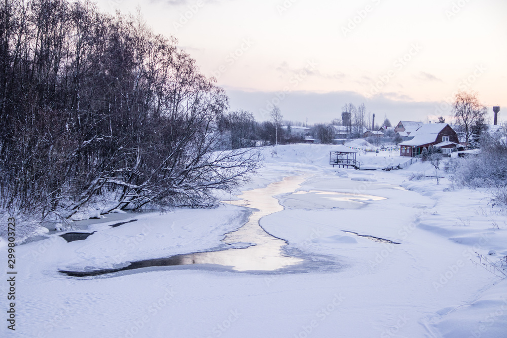 A small river in winter . Winter landscape. Water in rivers. Winter trees. Snow.