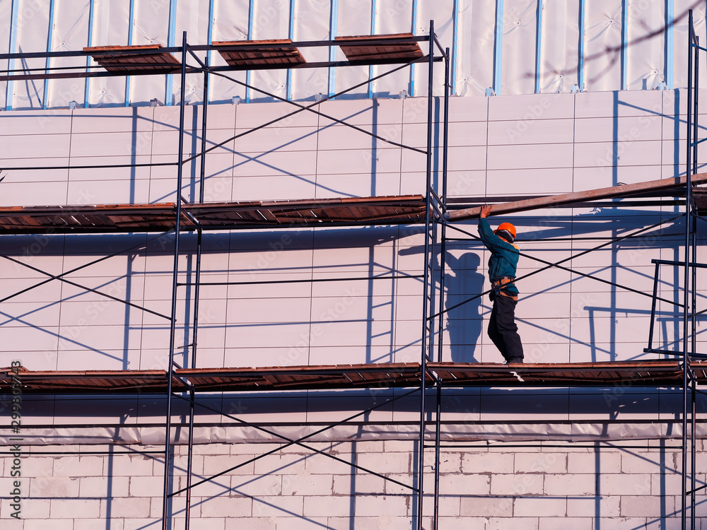 Worker constructing wooden scaffold background
