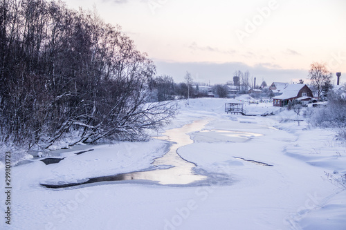 Fototapeta Naklejka Na Ścianę i Meble -  A small river in winter . Winter landscape. Water in rivers. Winter trees. Snow.