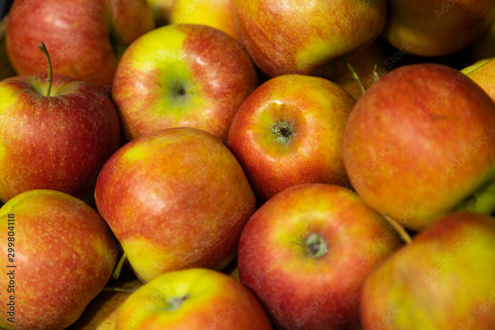 Closeup of fresh red-green apples on supermarket counter Closeup of fresh red-green apples on supermarket counter