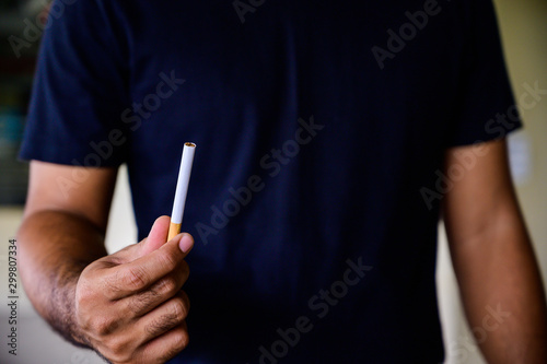 Cigarette in hand man. Stop smoking concept