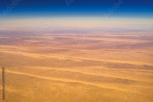 Aerial airplane view of barren Sahara desert landscape in Egypt