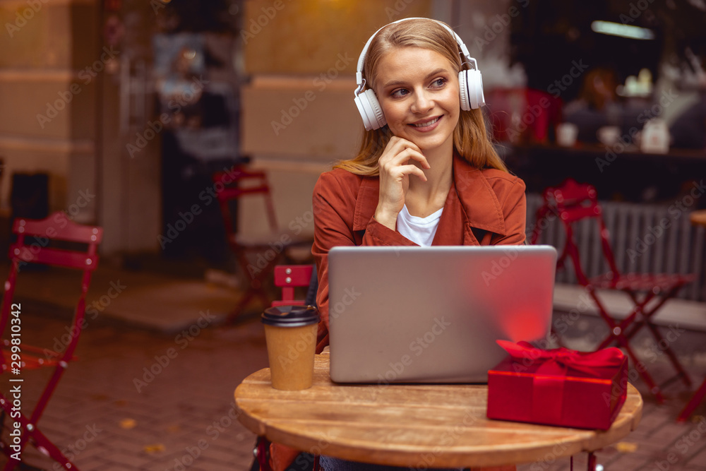 Smiling beautiful lady in headphones looking away Smiling beautiful lady in headphones looking away